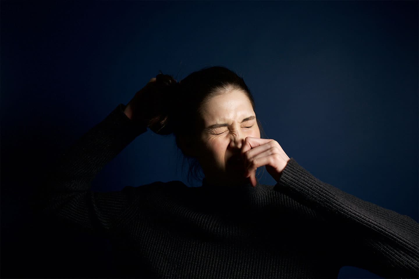 a woman getting ready to sneeze