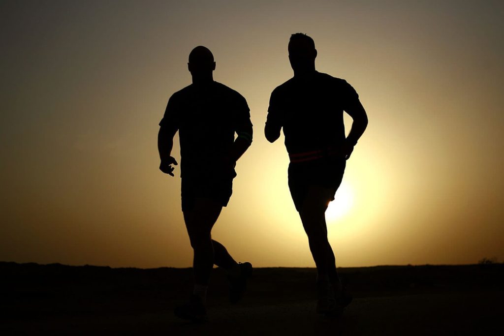 two men running in the sunset