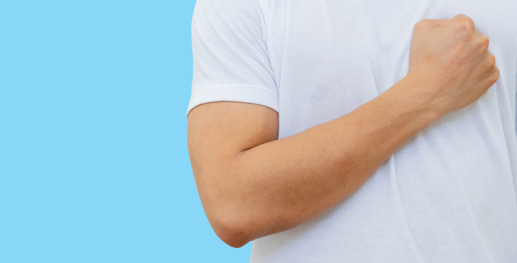 Man in white t-shirt flexing his arm.