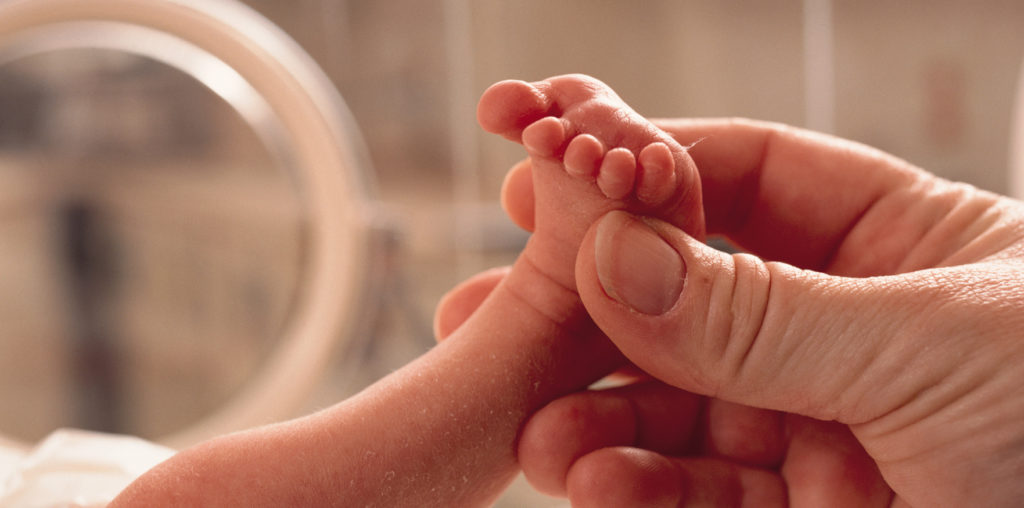 Parent Holding Preemie Baby's Foot