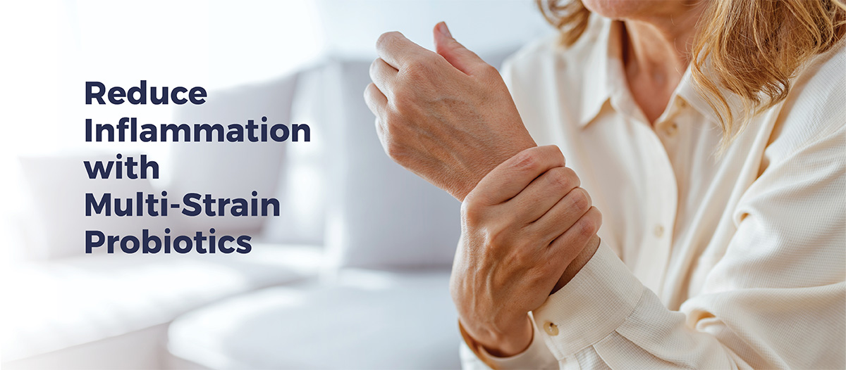 Senior woman gripping wrist. Overlayed text on image reads: "Reduce inflammation with multi-strain probiotics