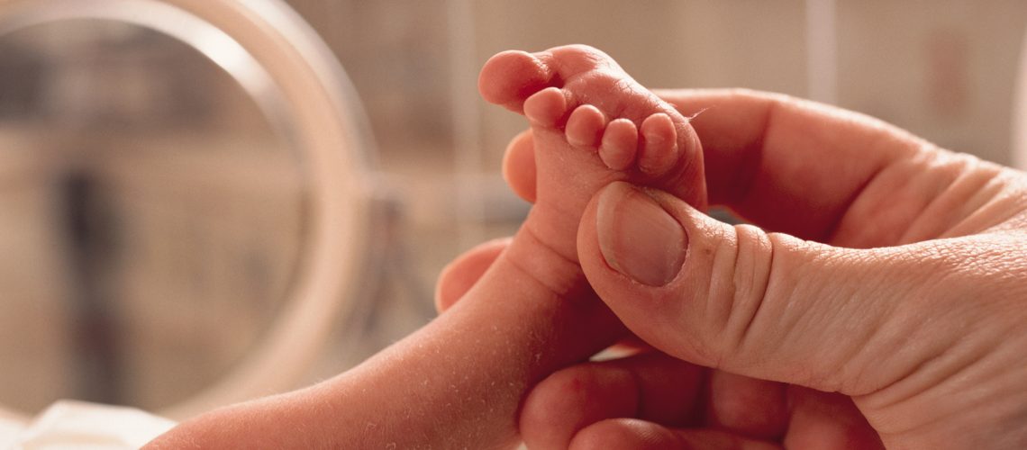 Parent Holding Preemie Baby's Foot