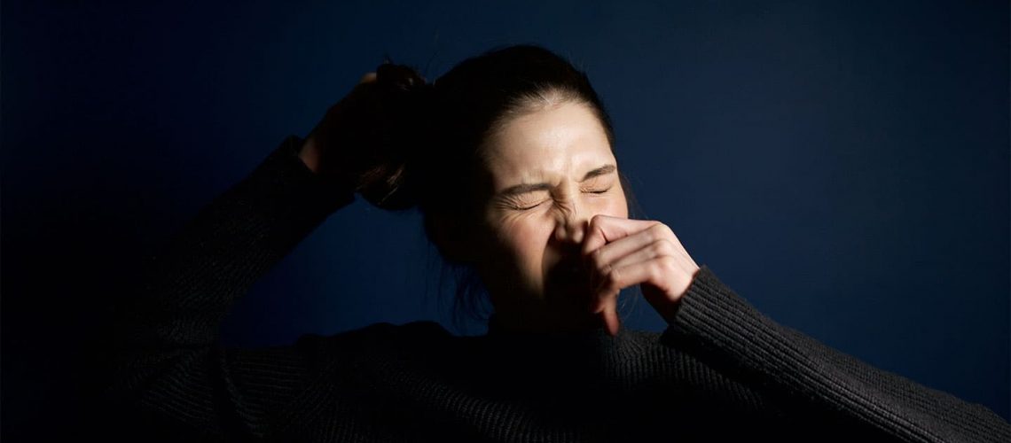 a woman getting ready to sneeze