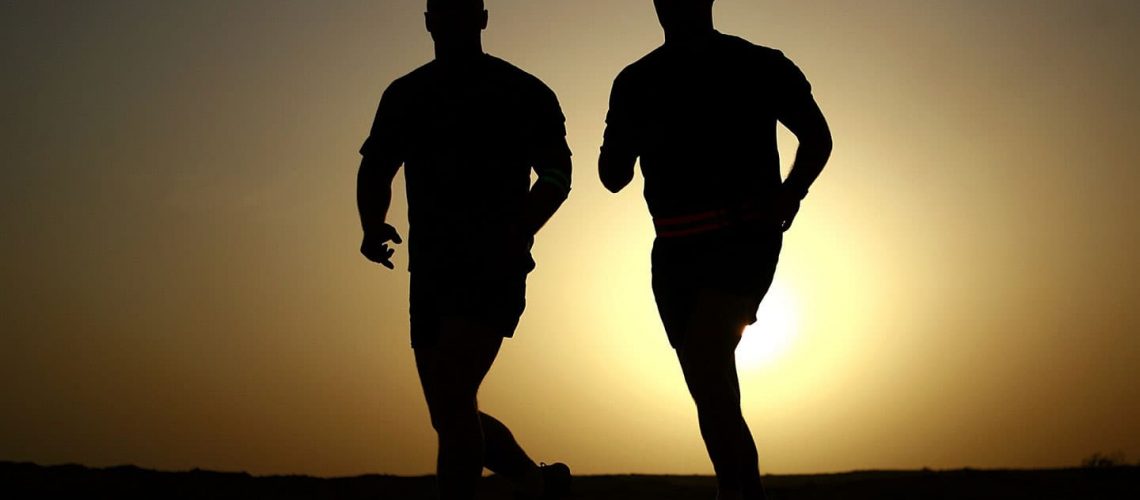 two men running in the sunset